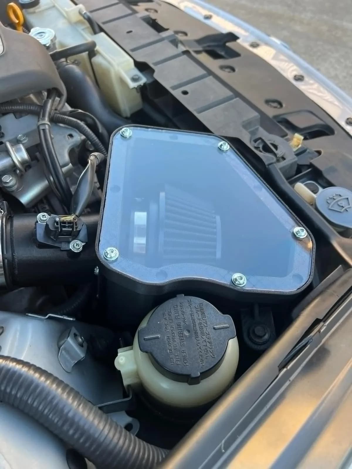 Roccomotive twin intake airbox with clear cover fitted in a Nissan 370Z engine bay